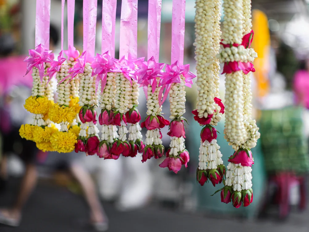 Strands of pink, white and yellow flower lei hanging together